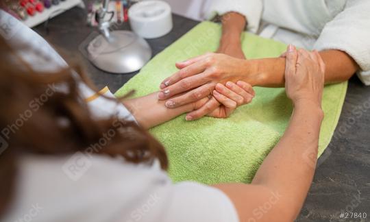 Woman receiving a massage in a beauty salon with a manicurist working on her nails  : Stock Photo or Stock Video Download rcfotostock photos, images and assets rcfotostock | RC Photo Stock.: