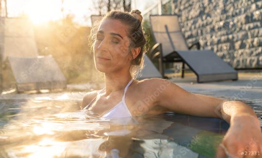 Woman relaxing in hot tub with sunflare, serene expression at wellness hotel  : Stock Photo or Stock Video Download rcfotostock photos, images and assets rcfotostock | RC Photo Stock.: