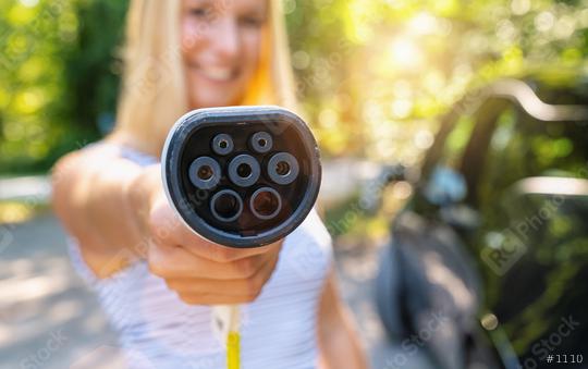 Woman shows Type 2 plug charging cable for Electric car or EV Car to charging. Eco-friendly alternative energy concept   : Stock Photo or Stock Video Download rcfotostock photos, images and assets rcfotostock | RC Photo Stock.: