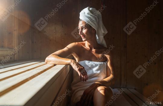 Woman sitting in a finnish sauna, leaning on one arm, with a towel wrapped around her head, sunlight streaming in at wellness spa hotel  : Stock Photo or Stock Video Download rcfotostock photos, images and assets rcfotostock | RC Photo Stock.: