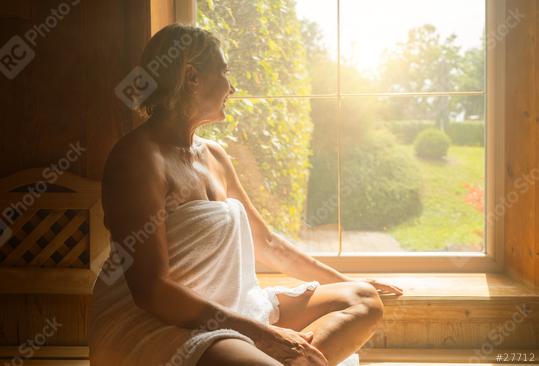 woman sitting on a wooden bench in a sauna, looking out of a window  : Stock Photo or Stock Video Download rcfotostock photos, images and assets rcfotostock | RC Photo Stock.: