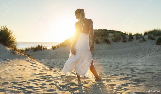 woman stands barefoot through sand dunes towards to sea at summer sunset  : Stock Photo or Stock Video Download rcfotostock photos, images and assets rcfotostock | RC Photo Stock.: