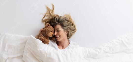 woman that cuddles with her teddy bear sleeping on white bed and lying under blanket, Top view,  copyspace for your individual text.  : Stock Photo or Stock Video Download rcfotostock photos, images and assets rcfotostock | RC Photo Stock.: