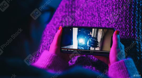 Woman watching crime movie on mobile phone with imaginary video player service. Online movie stream with smartphone.   : Stock Photo or Stock Video Download rcfotostock photos, images and assets rcfotostock | RC Photo Stock.: