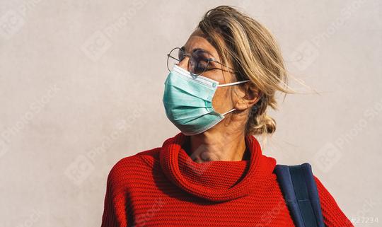 woman wearing a turquoise face mask and round glasses gazes to the side, dressed in a vibrant red sweater with a blue bag strap visible  : Stock Photo or Stock Video Download rcfotostock photos, images and assets rcfotostock | RC Photo Stock.: