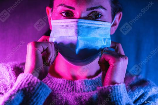 woman wearing anti virus face mask protection in colourful bright neon uv lights posing at home   : Stock Photo or Stock Video Download rcfotostock photos, images and assets rcfotostock | RC Photo Stock.: