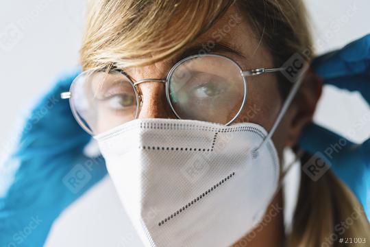 Woman wearing N95 FFP2 an anti virus protection mask and glasses are fogged up to prevent others from corona COVID-19 and SARS cov 2 infection  : Stock Photo or Stock Video Download rcfotostock photos, images and assets rcfotostock | RC Photo Stock.: