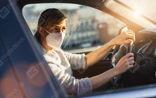 woman with a N95 FFP2 anti virus mask sitting in a car and looks around, protective mask against coronavirus, driver on a city street during a coronavirus outbreak, covid-19.  : Stock Photo or Stock Video Download rcfotostock photos, images and assets rcfotostock | RC Photo Stock.: