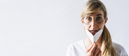 Woman with knN95 FFP2 an anti virus protection face mask off. Woman removing protective face mask to take a deep breath during COVID-19 corona pandemic. Woman throwing away her mask, with copy space  : Stock Photo or Stock Video Download rcfotostock photos, images and assets rcfotostock | RC Photo Stock.: