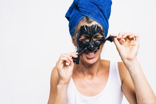 Young attractive girl takes off black facial face. with wrapped bath towel on the head in blue color  : Stock Photo or Stock Video Download rcfotostock photos, images and assets rcfotostock | RC Photo Stock.: