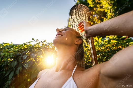 young attractive woman having a shower before jumping in the resort pool. Golden Hour Refreshment Spa wellness concept image  : Stock Photo or Stock Video Download rcfotostock photos, images and assets rcfotostock | RC Photo Stock.: