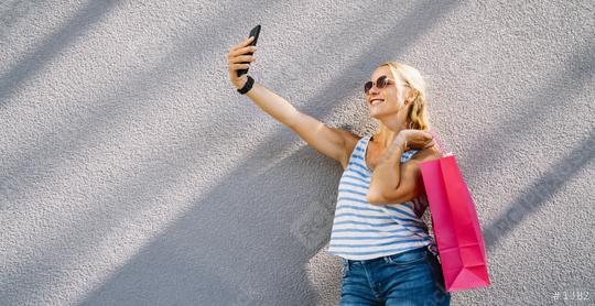 Young attractive woman taking selfie with smartphone with shopping bag after shopping. holding mobile phone and doing selfie.  : Stock Photo or Stock Video Download rcfotostock photos, images and assets rcfotostock | RC Photo Stock.: