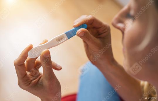 young attractive woman with glasses holding pregnancy test at home looking at positive result in shock and stress having surprise in girl unwanted maternity concept image  : Stock Photo or Stock Video Download rcfotostock photos, images and assets rcfotostock | RC Photo Stock.: