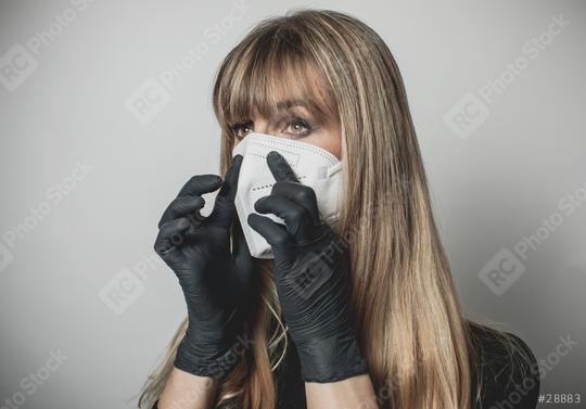 young, blond beautiful woman puts ffp2 protective mask on with protective medical gloves for protection against corona  : Stock Photo or Stock Video Download rcfotostock photos, images and assets rcfotostock | RC Photo Stock.: