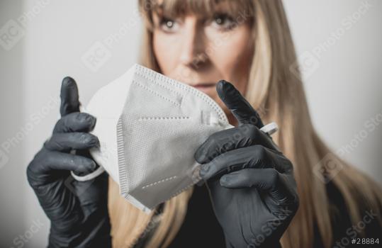 young, blond beautiful woman puts ffp2 protective mask on with protective medical gloves for protection against corona  : Stock Photo or Stock Video Download rcfotostock photos, images and assets rcfotostock | RC Photo Stock.: