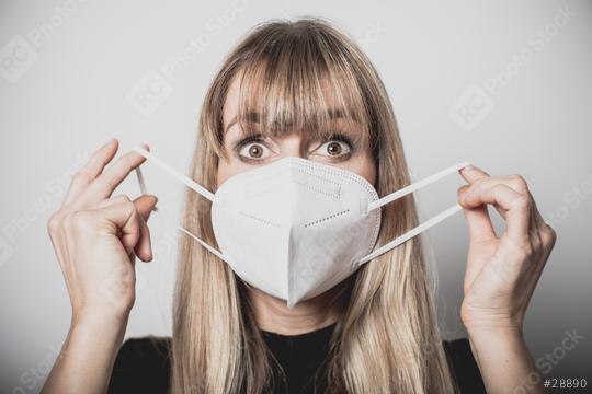 young, blond beautiful woman puts ffp2 protective mask on with protective medical gloves for protection against corona  : Stock Photo or Stock Video Download rcfotostock photos, images and assets rcfotostock | RC Photo Stock.: