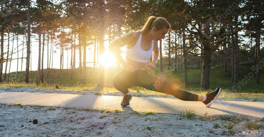 Young female workout before fitness training session at beach. Healthy young woman warming up outdoors. She is stretches her legs a path at sunrise.  : Stock Photo or Stock Video Download rcfotostock photos, images and assets rcfotostock | RC Photo Stock.: