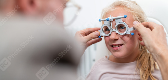 Young girl getting her eyesight tested with Optical measuring gl  : Stock Photo or Stock Video Download rcfotostock photos, images and assets rcfotostock | RC Photo Stock.: