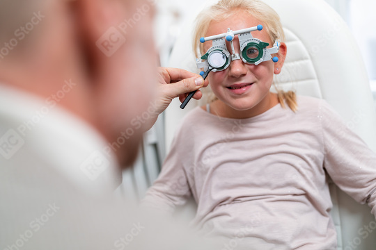 Young girl in a vision test or eye exam for eyesight by doctor,   : Stock Photo or Stock Video Download rcfotostock photos, images and assets rcfotostock | RC Photo Stock.: