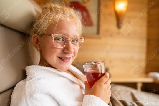 young girl in a white robe holding a tea cup, relaxing in a lounger at a wellness spa hotel, smiling warmly  : Stock Photo or Stock Video Download rcfotostock photos, images and assets rcfotostock | RC Photo Stock.: