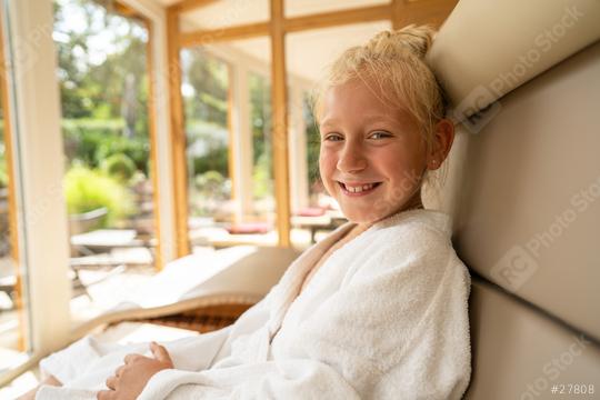 young girl relaxing in a lounger at a wellness spa hotel, smiling in a white robe, with a sunny garden view  : Stock Photo or Stock Video Download rcfotostock photos, images and assets rcfotostock | RC Photo Stock.: