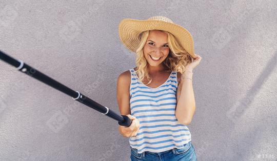 Young girl smiling and use selfie stick to take a selfie, on summer in city street. Urban life concept.  : Stock Photo or Stock Video Download rcfotostock photos, images and assets rcfotostock | RC Photo Stock.: