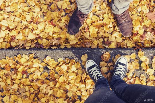 young man and a girl in sneakers stands opposite on a curbside at autumn with yellow foliage, high angle footsie or flortrait, personal pespective from above.  : Stock Photo or Stock Video Download rcfotostock photos, images and assets rcfotostock | RC Photo Stock.: