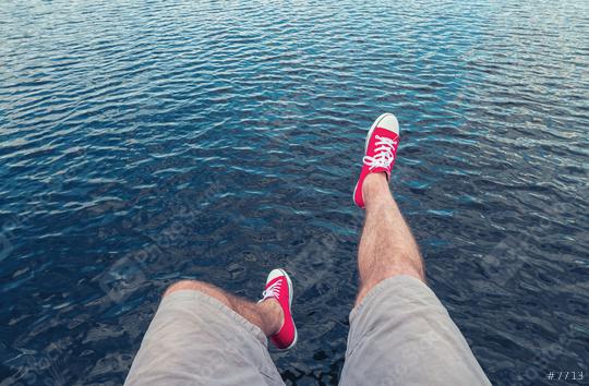 Young man in red sneakers jumps in to the ocean, Point of view shot  : Stock Photo or Stock Video Download rcfotostock photos, images and assets rcfotostock | RC Photo Stock.: