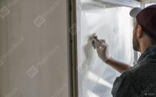 young man is using a sponge to clean a windows. professional window cleaner  : Stock Photo or Stock Video Download rcfotostock photos, images and assets rcfotostock | RC Photo Stock.: