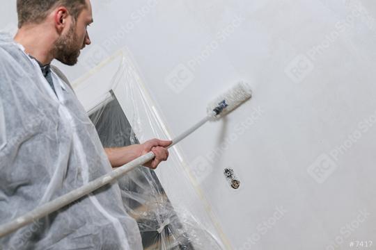 young man painting a wall with roller in with color. do it yourself concept image  : Stock Photo or Stock Video Download rcfotostock photos, images and assets rcfotostock | RC Photo Stock.: