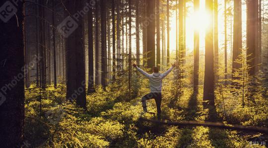 Young man raised hands stand in deep forrest and enjoys nature and sunlight - Travel Lifestyle emotional concept  : Stock Photo or Stock Video Download rcfotostock photos, images and assets rcfotostock | RC-Photo-Stock.: