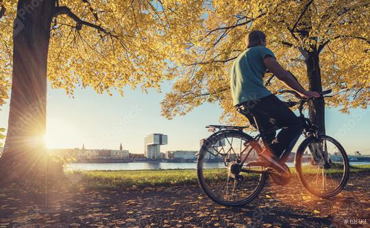 young man ride a bicycle at the rhine shore in cologne, germany  : Stock Photo or Stock Video Download rcfotostock photos, images and assets rcfotostock | RC Photo Stock.: