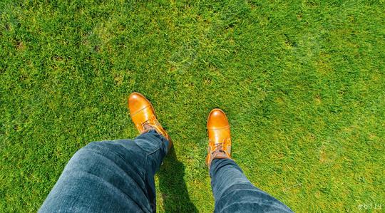 Young man standing in freshly mown grass lawn, top view of casually dressed person in leather shoes  : Stock Photo or Stock Video Download rcfotostock photos, images and assets rcfotostock | RC Photo Stock.: