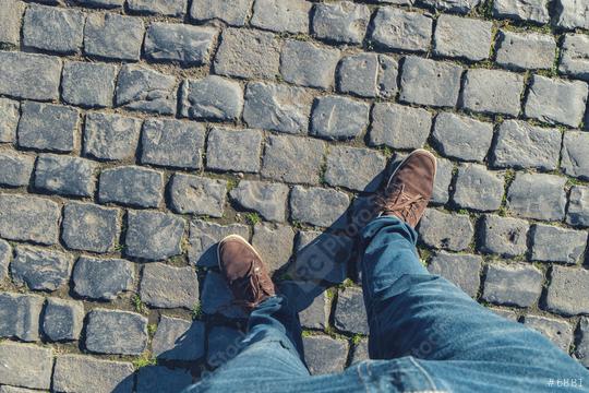 young man stands on cobblestones, high angle footsie or flortrait, personal pespective from above.  : Stock Photo or Stock Video Download rcfotostock photos, images and assets rcfotostock | RC Photo Stock.: