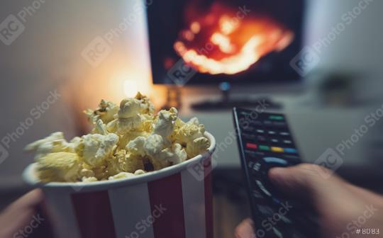 young man watching a movie with popcorn and remote controller, Point of view shot   : Stock Photo or Stock Video Download rcfotostock photos, images and assets rcfotostock | RC Photo Stock.: