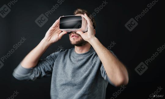 young man wearing Virtual Reality goggles VR Headset on black background  : Stock Photo or Stock Video Download rcfotostock photos, images and assets rcfotostock | RC Photo Stock.: