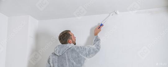 young painter working with paint roller to paint the ceiling of a room with white color. do it yourself concept image  : Stock Photo or Stock Video Download rcfotostock photos, images and assets rcfotostock | RC Photo Stock.: