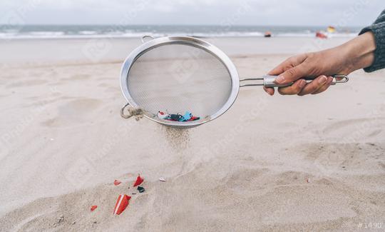 Young woman cleaning microplastics from sand on the beach, Environmental problem, pollution, ecolosystem and climate change warning concept   : Stock Photo or Stock Video Download rcfotostock photos, images and assets rcfotostock | RC Photo Stock.: