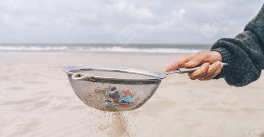 Young woman cleaning microplastics from sand on the beach, Environmental problem, pollution, ecolosystem and climate change warning concept   : Stock Photo or Stock Video Download rcfotostock photos, images and assets rcfotostock | RC-Photo-Stock.: