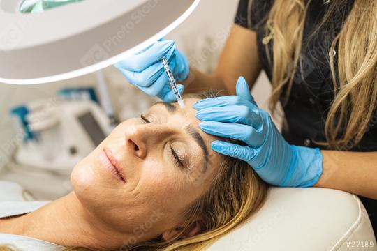 young woman gets injection of Anti-aging face treatment in her forehead. Woman in beauty salon. plastic surgery clinic.  : Stock Photo or Stock Video Download rcfotostock photos, images and assets rcfotostock | RC Photo Stock.: