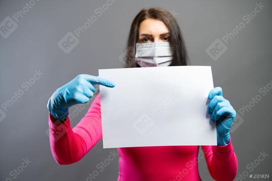 Young woman in medical mask and gloves showing empty blank paper in her hands. Focus on a piece of paper. prevent others from corona COVID-19 and SARS cov 2 infection, copy space for individual text  : Stock Photo or Stock Video Download rcfotostock photos, images and assets rcfotostock | RC Photo Stock.: