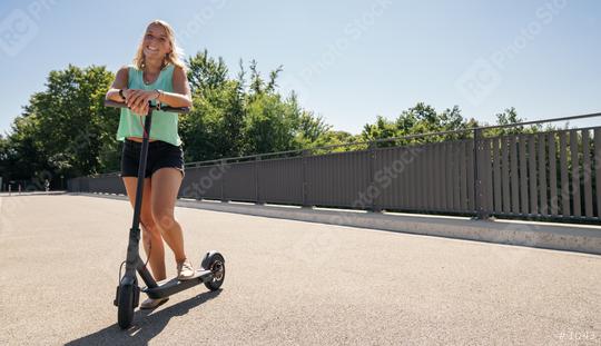 Young woman is ready to riding a black electric kick scooter at cityscape, copyspace for your individual text.  : Stock Photo or Stock Video Download rcfotostock photos, images and assets rcfotostock | RC Photo Stock.:
