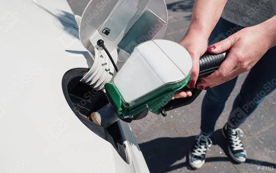 Young woman refueling car tank at a fuel station  : Stock Photo or Stock Video Download rcfotostock photos, images and assets rcfotostock | RC Photo Stock.: