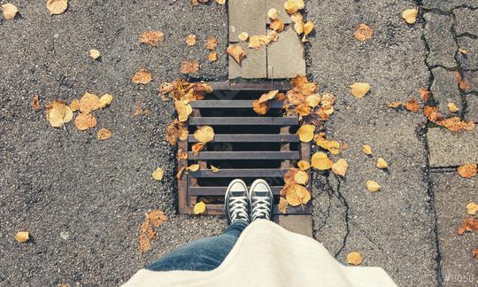 Young woman standing at autumn on a manhole cover at the streets, personal pespective from above.  : Stock Photo or Stock Video Download rcfotostock photos, images and assets rcfotostock | RC Photo Stock.: