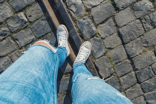 Young woman stands cobblestones on a train track, personal pespective from above.  : Stock Photo or Stock Video Download rcfotostock photos, images and assets rcfotostock | RC Photo Stock.: