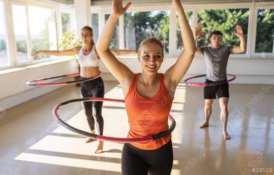 Young women an men doing hula hoop during an exercise class in a gym. Healthy sports lifestyle, Fitness, Healthy concept.  : Stock Photo or Stock Video Download rcfotostock photos, images and assets rcfotostock | RC Photo Stock.: